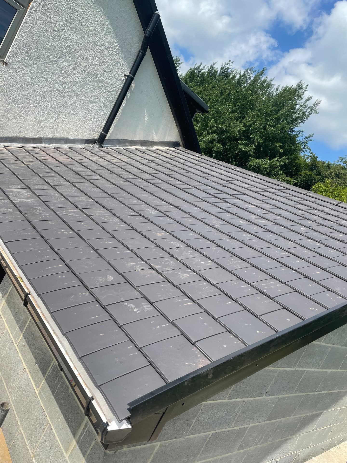 New flat slate-effect roof on a house extension