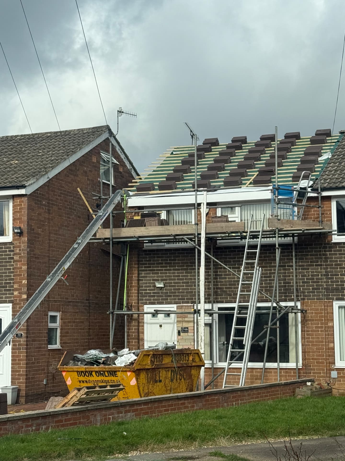 Strip and re-tile job in progress with scaffolding in Leeds