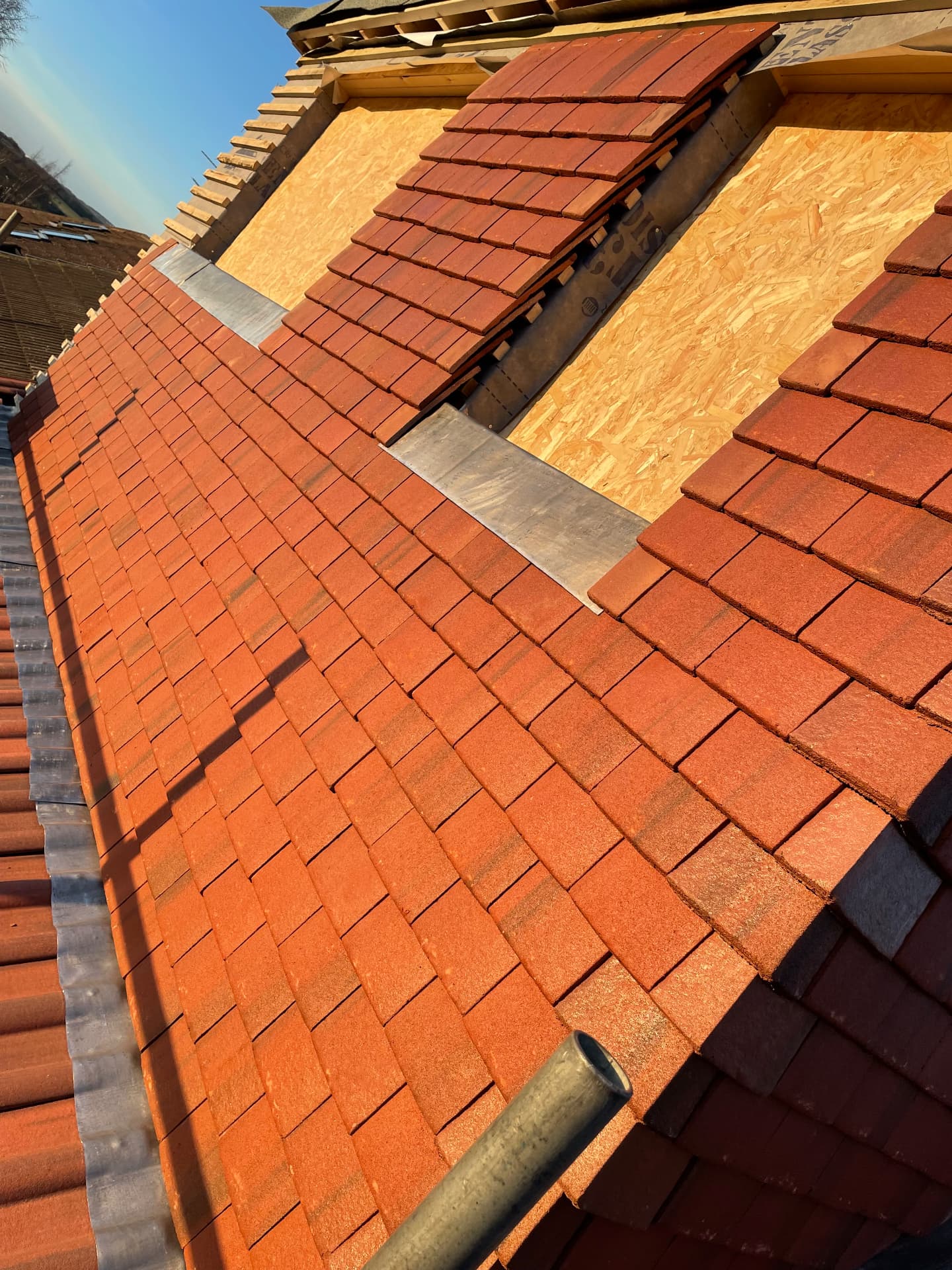 New clay tiles being laid on a roof